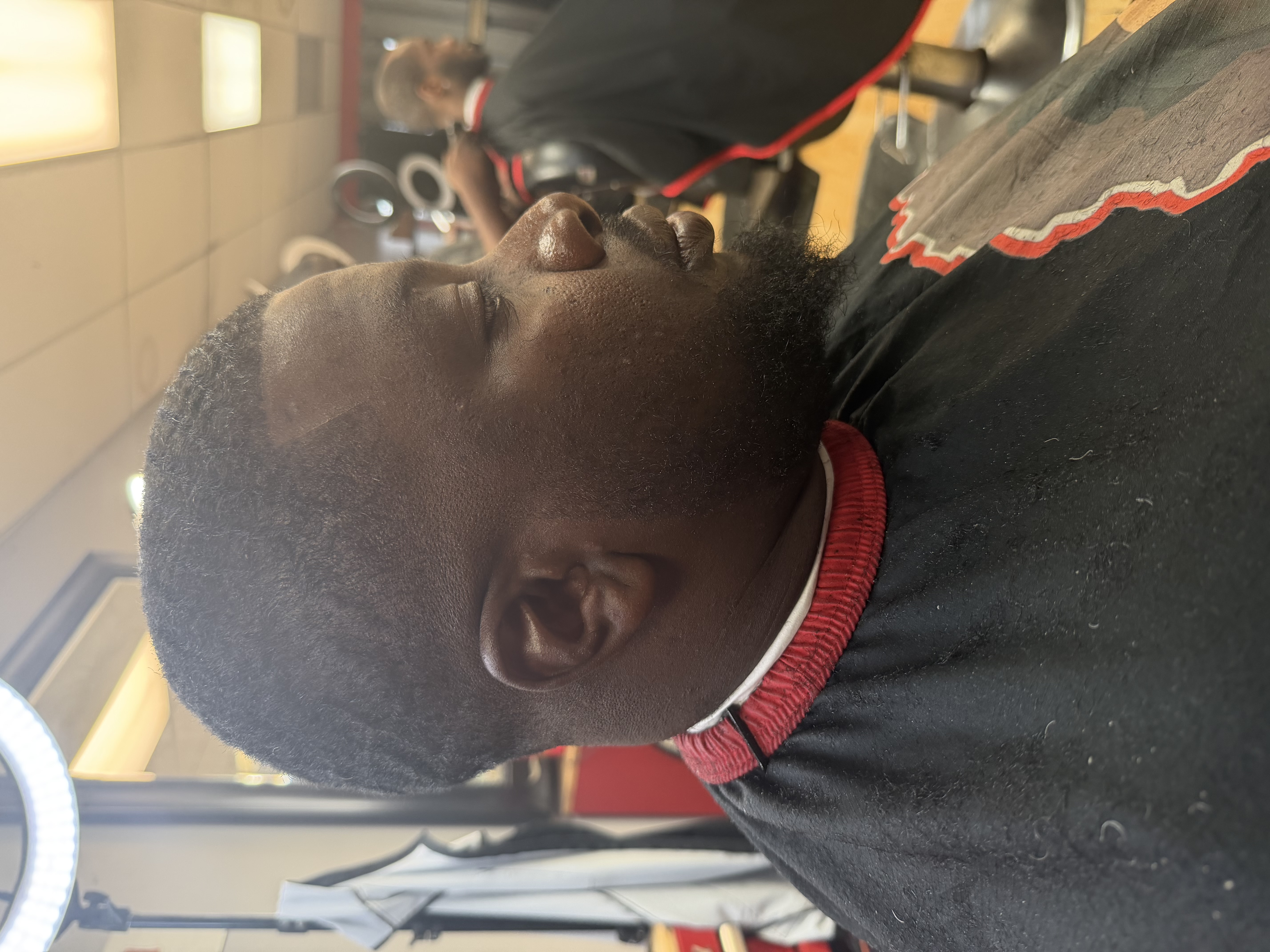 Client after a taper cut and lineup at Nu Trendz Hair Studio
