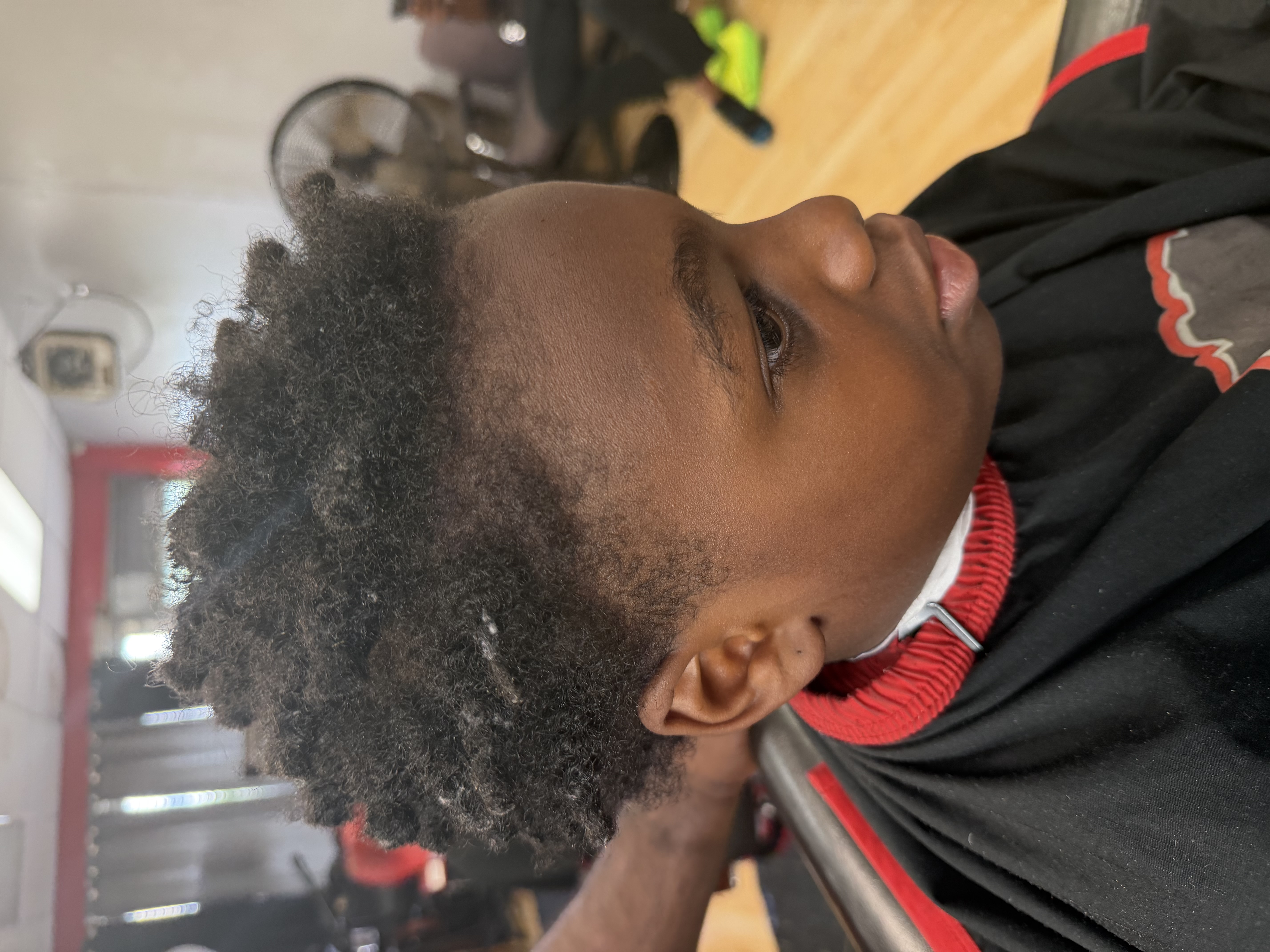 Young client after his locs were cut down into a short tapered style