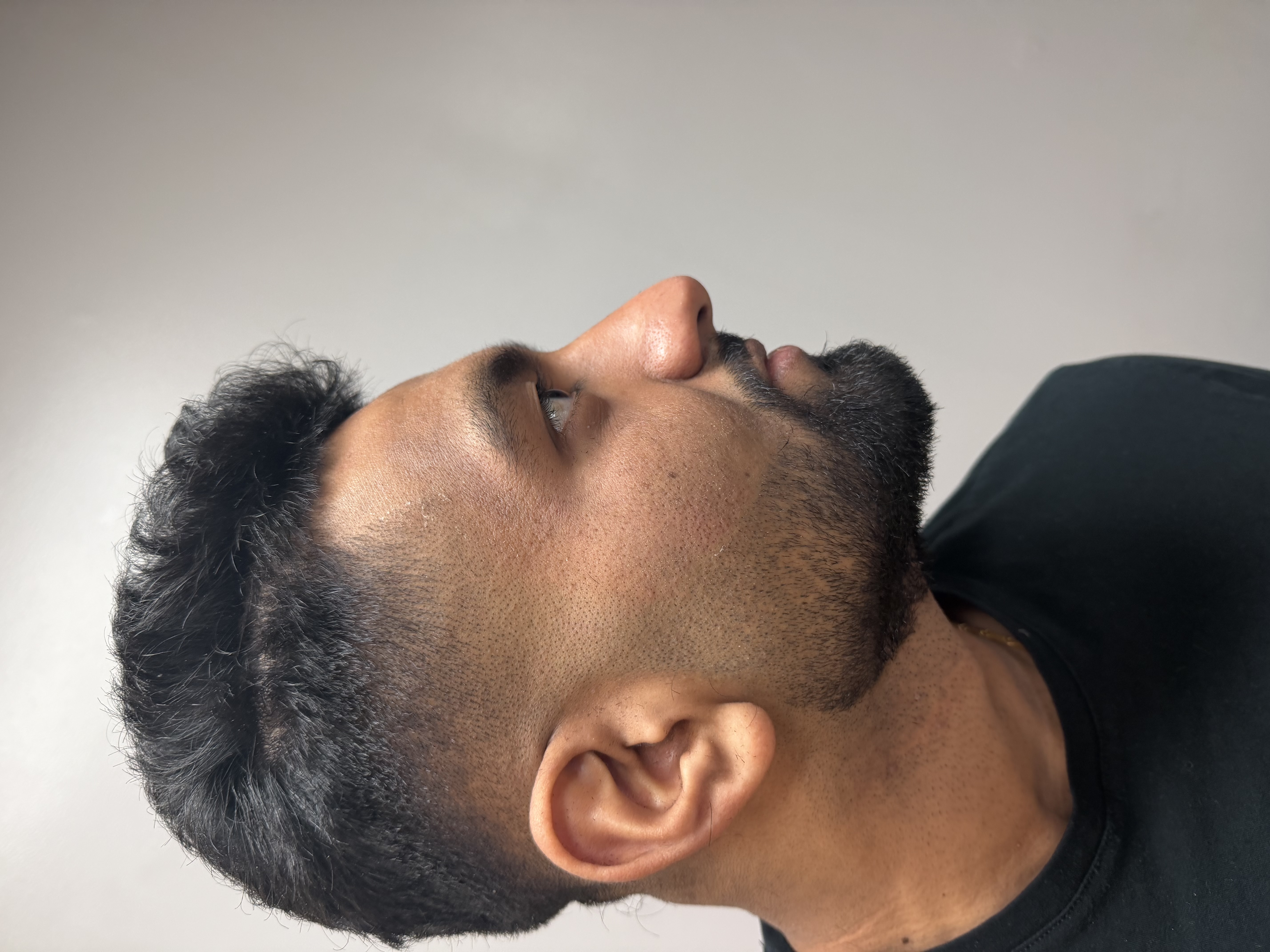 Client after a mid fade with a textured top and shaped beard