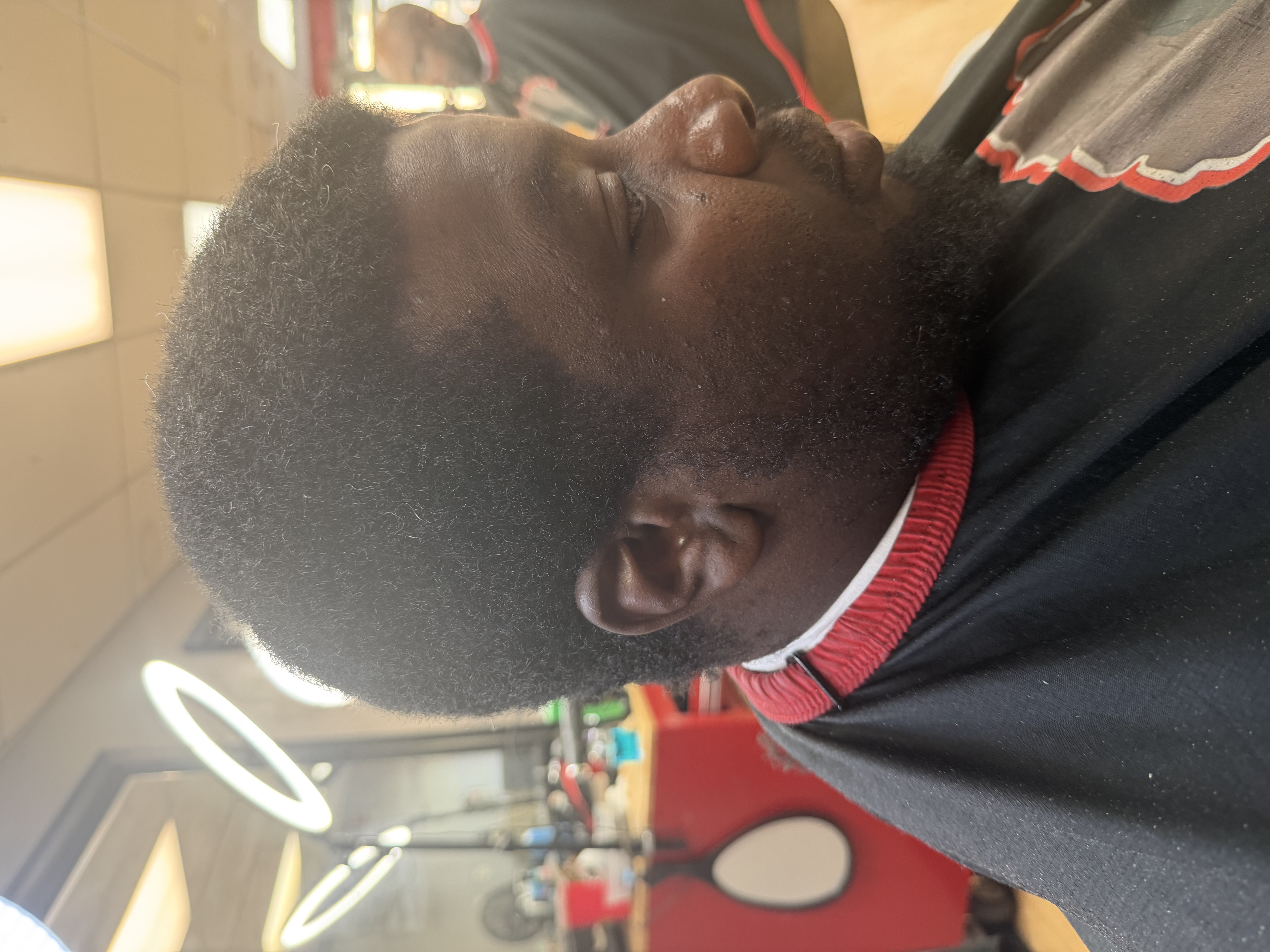 The same client before the cut, with a grown-out afro